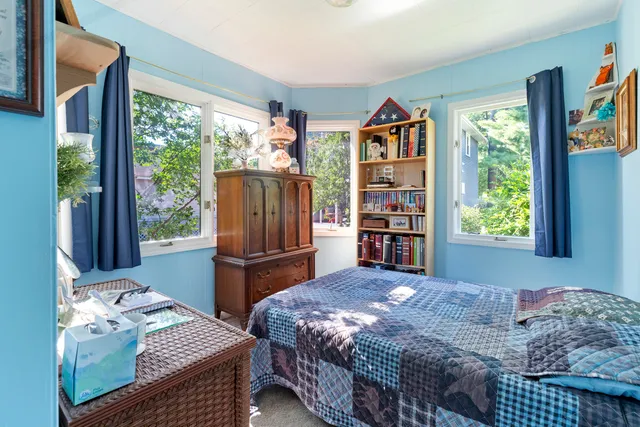 a bed room with a bed and a chair