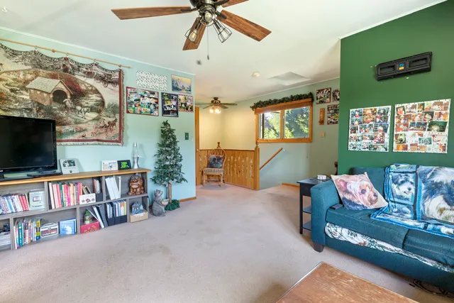 a view of a hallway with wooden floor and windows