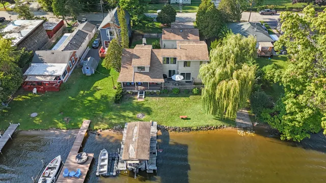 an aerial view of a house with a yard basket ball court and outdoor seating