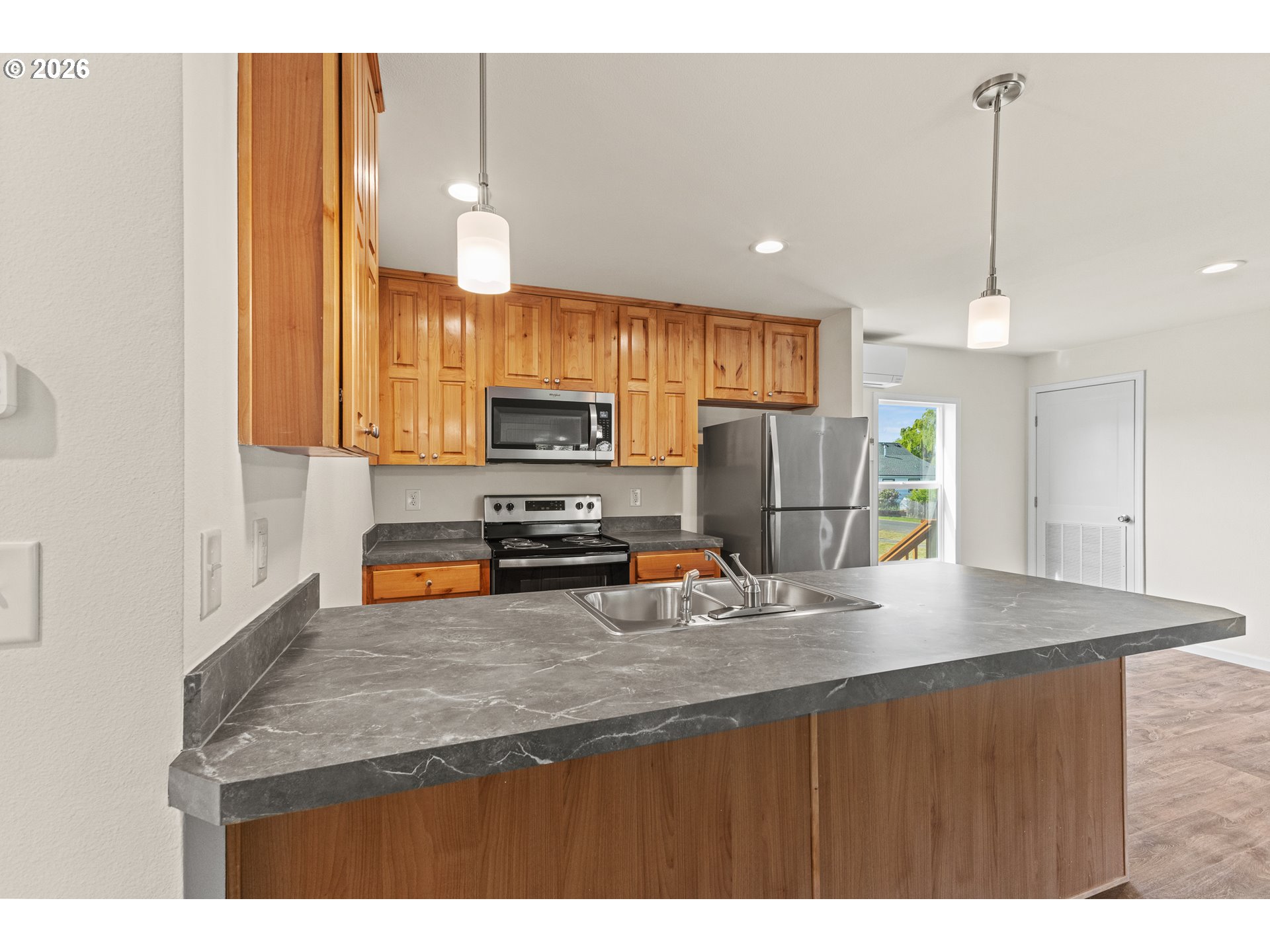 1314 Bothwick Street Myrtle Point, OR 97458 - Photo 15 of 38 a kitchen with stainless steel appliances granite countertop a sink refrigerator and microwave