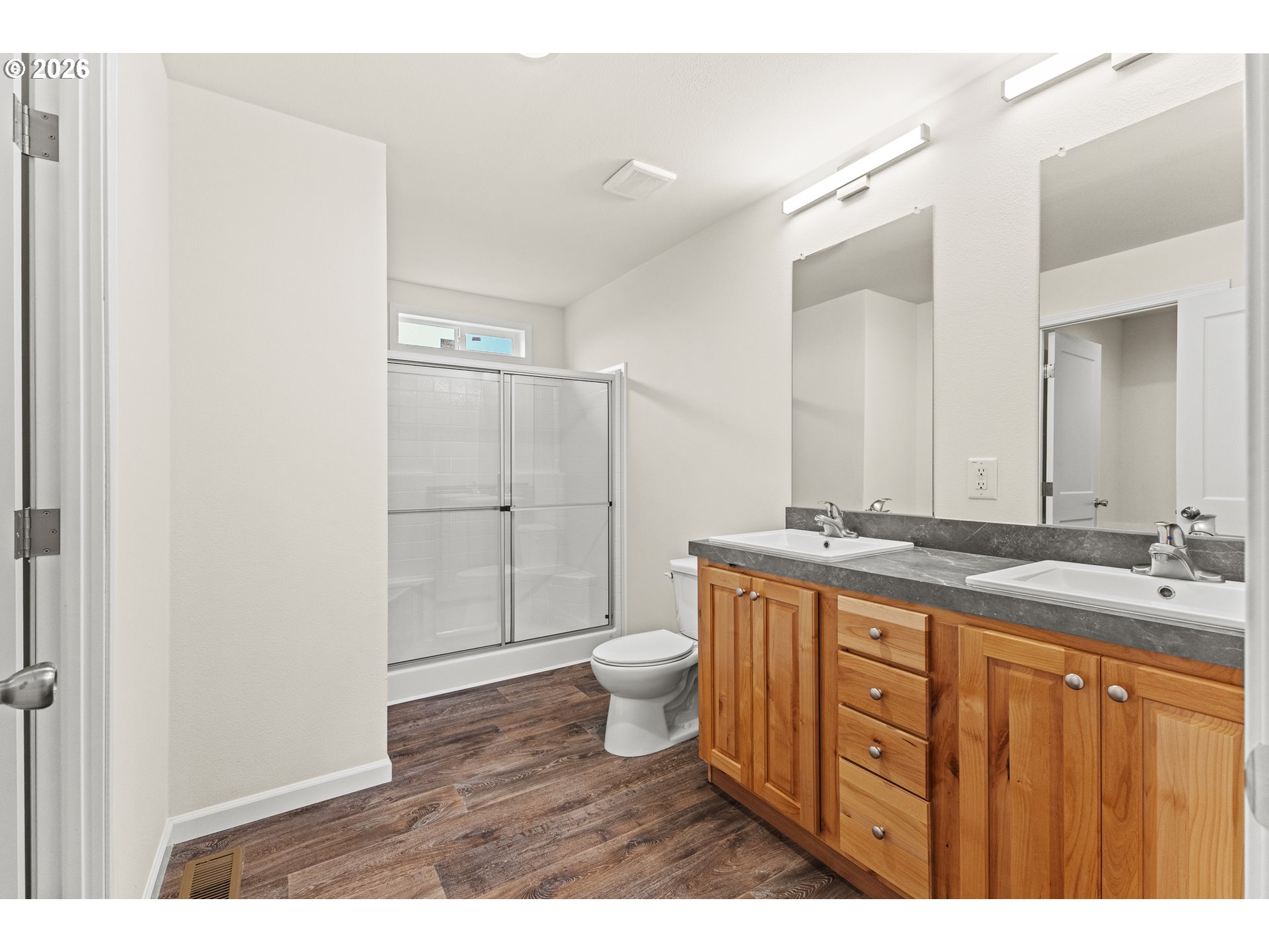 1314 Bothwick Street Myrtle Point, OR 97458 - Photo 19 of 38 a bathroom with a double vanity sink a toilet and a mirror