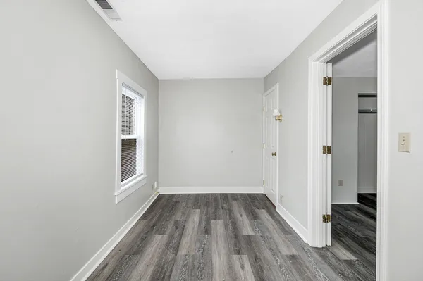a view of a room with wooden floor and staircase