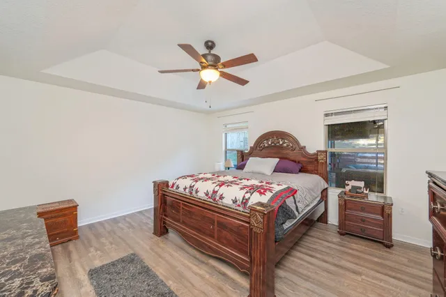 a bedroom with a bed and wooden floor