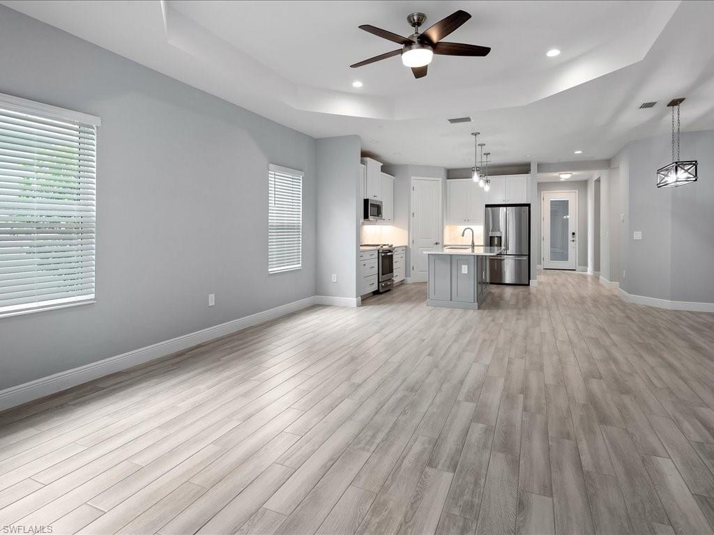 2119 Marquesa Circle Naples, FL 34112 - Photo 19 of 44 a view of empty room with wooden floor and window