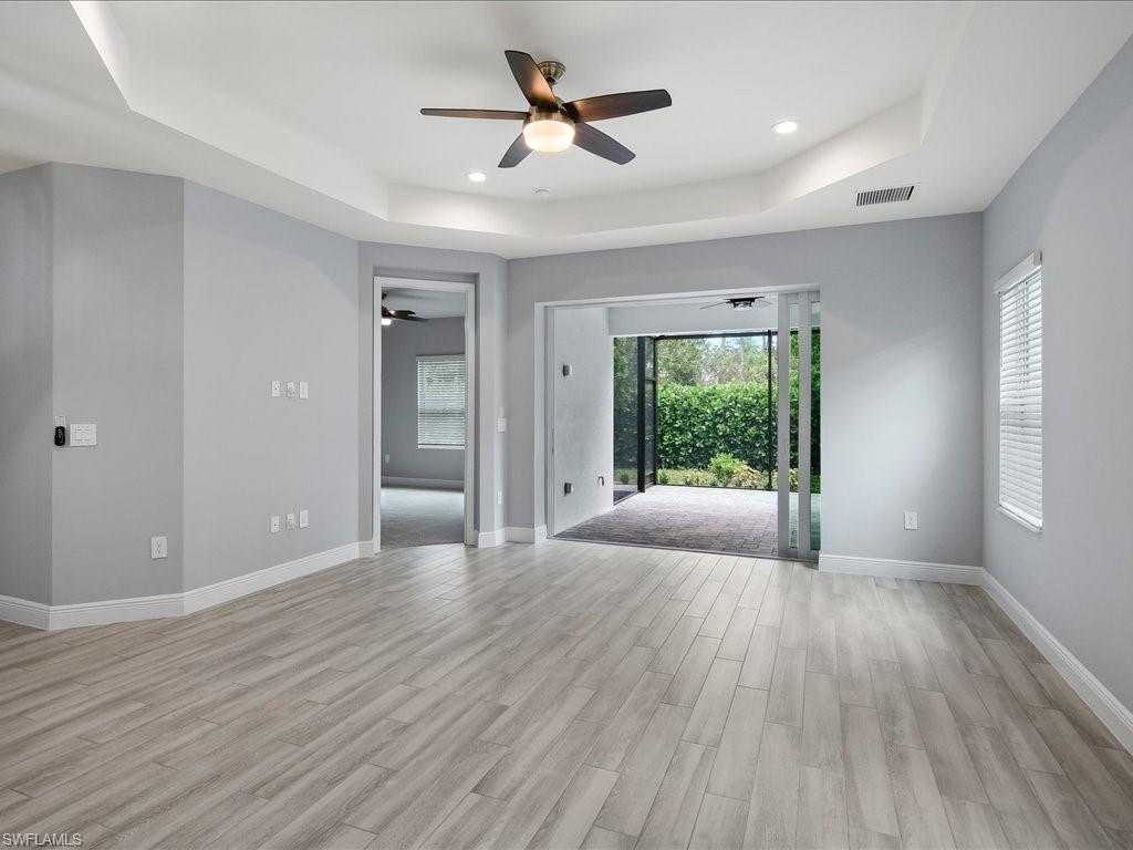 2119 Marquesa Circle Naples, FL 34112 - Photo 20 of 44 a view of n empty room with window and wooden floor