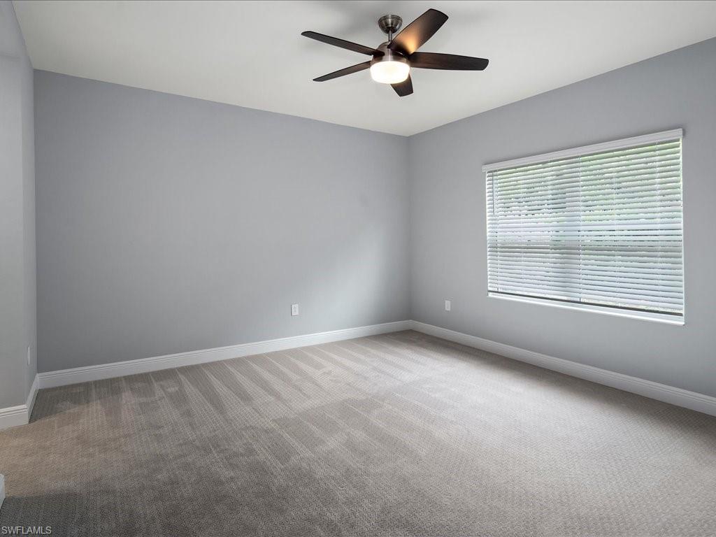 2119 Marquesa Circle Naples, FL 34112 - Photo 21 of 44 a view of an empty room with a window