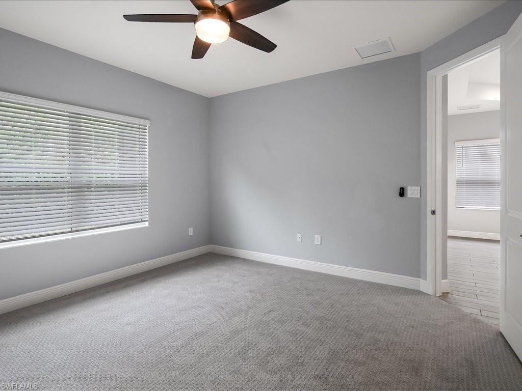 2119 Marquesa Circle Naples, FL 34112 - Photo 22 of 44 a view of an empty room with a window