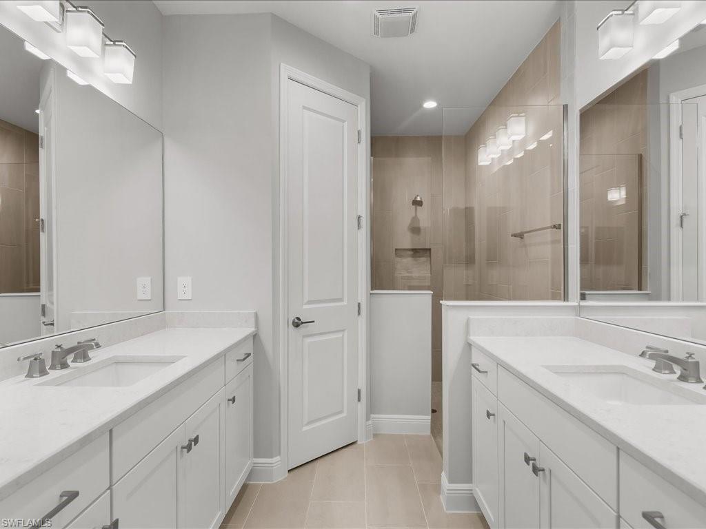2119 Marquesa Circle Naples, FL 34112 - Photo 23 of 44 a bathroom with a sink double vanity and a mirror
