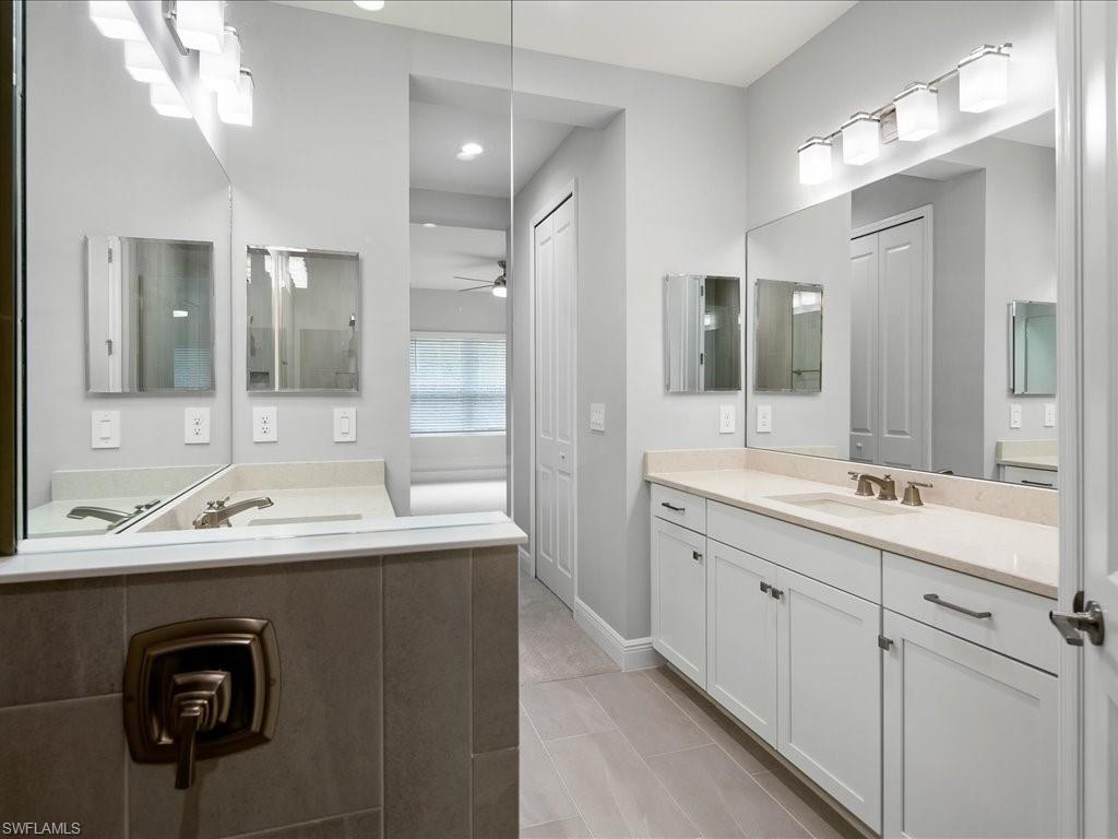 2119 Marquesa Circle Naples, FL 34112 - Photo 26 of 44 a bathroom with a sink double vanity granite and a mirror