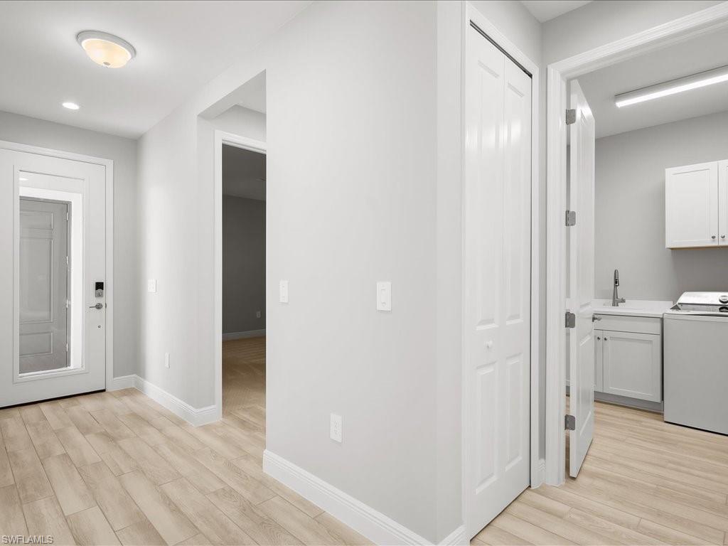 2119 Marquesa Circle Naples, FL 34112 - Photo 28 of 44 a view of a hallway with wooden floor