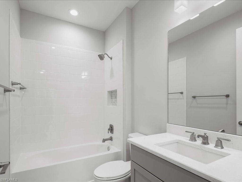 2119 Marquesa Circle Naples, FL 34112 - Photo 31 of 44 a bathroom with a sink toilet vanity and shower