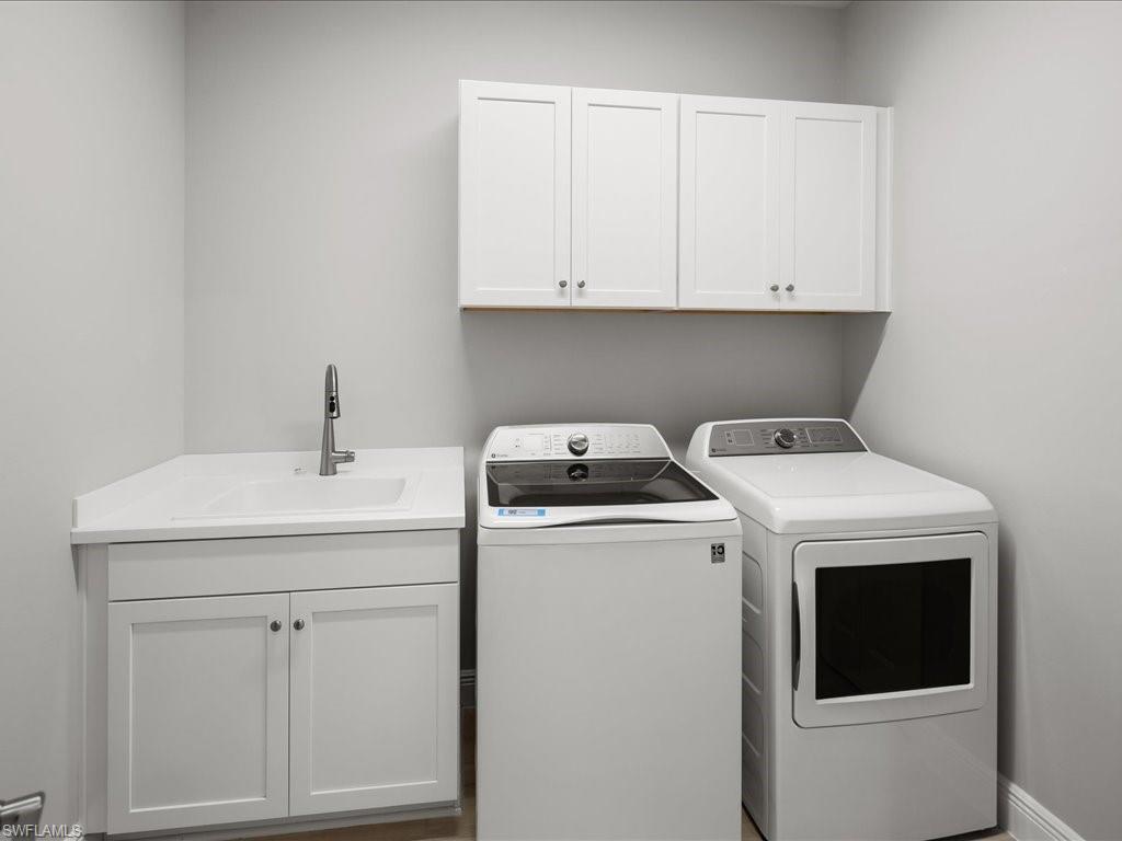 2119 Marquesa Circle Naples, FL 34112 - Photo 32 of 44 a utility room with dryer and washer