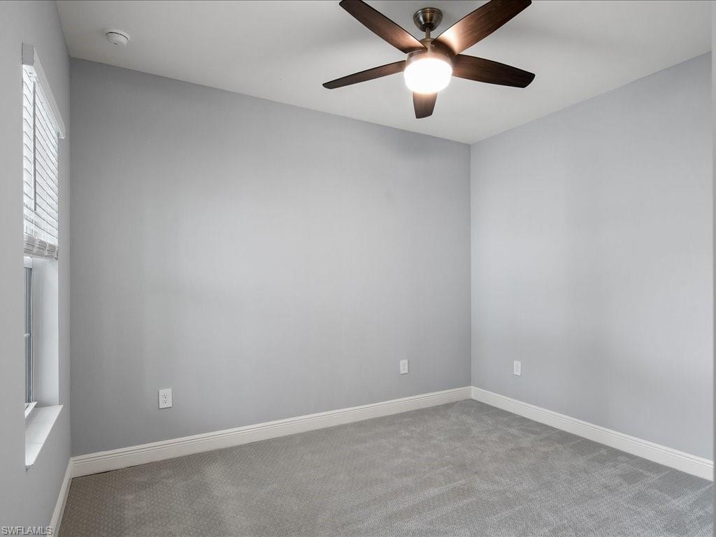 2119 Marquesa Circle Naples, FL 34112 - Photo 33 of 44 an empty room with a window and a fan