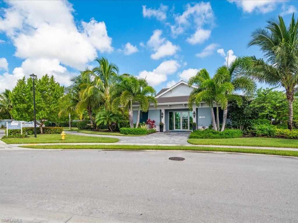 2119 Marquesa Circle Naples, FL 34112 - Photo 37 of 44 a view of a white house with a big yard and palm trees