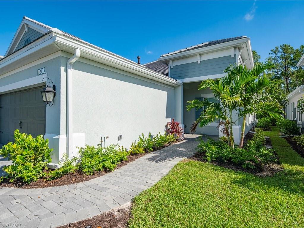 2119 Marquesa Circle Naples, FL 34112 - Photo 5 of 44 a front view of a house with garden