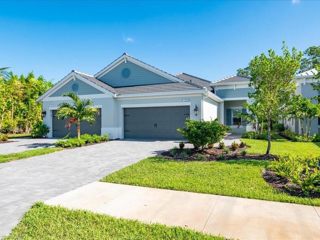 2119 Marquesa Circle Naples, FL 34112 - Photo 6 of 44 a front view of a house with a yard and garage