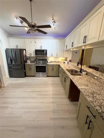 a view of walk in closet with clothes