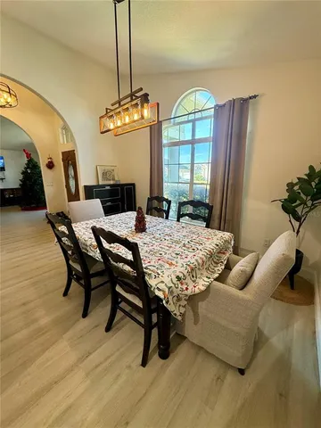 a kitchen with a sink a stove and chairs