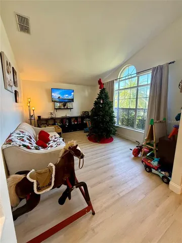 a bedroom with a bed and a flat tv screen on the dresser