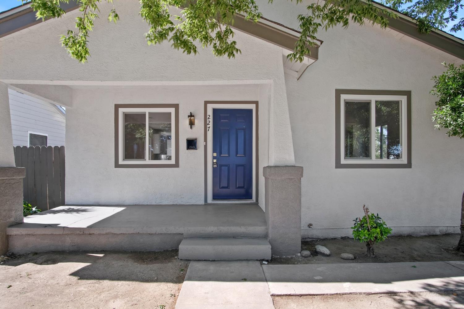227 Maple Street Modesto, CA 95351 - Photo 1 of 1 a view of a house with a potted plant and a bench in it