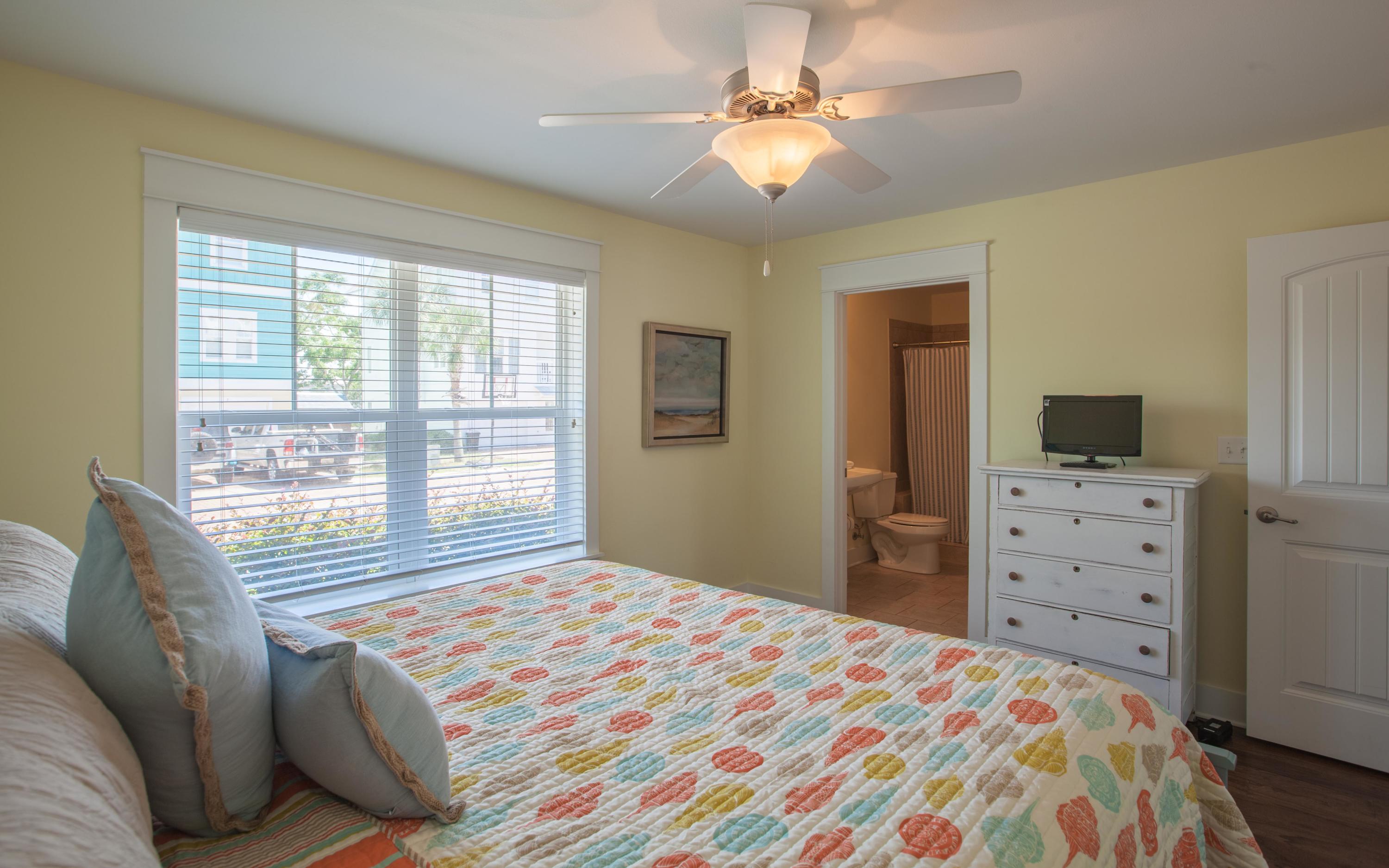 7 Windward Cove Santa Rosa Beach, FL 32459 - Photo 4 of 25 a bedroom with a bed a chandelier and a flat tv screen on dresser