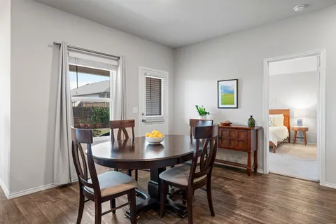 a view of a dining room with furniture and wooden floor
