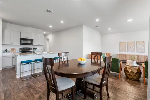 a bedroom with a bed couch and potted plant
