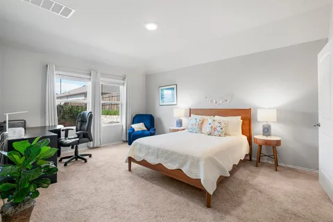 a bedroom with a bed and a couch