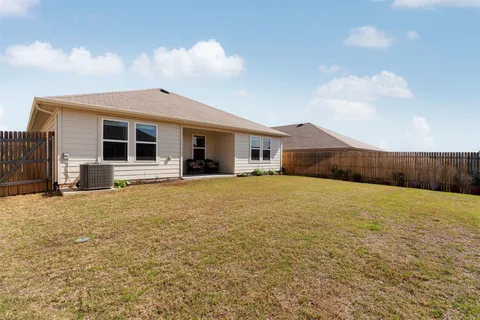 a front view of house with yard and car parked