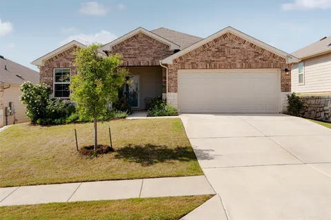 front view of house with potted plants
