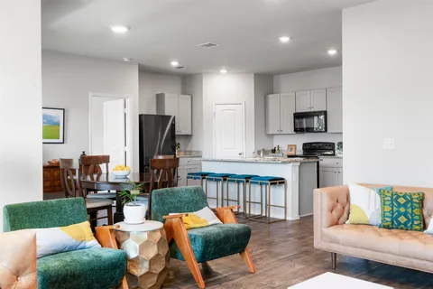 a kitchen with stainless steel appliances granite countertop a stove a sink a refrigerator a microwave and cabinets