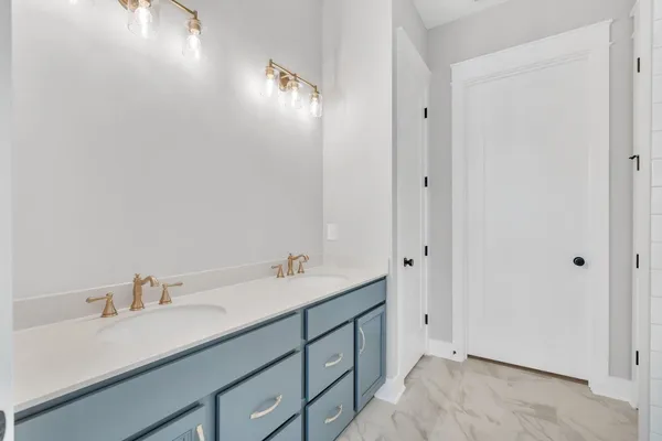 a bathroom with a double vanity sink and mirror