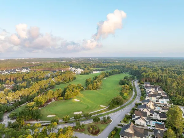 an aerial view of lake and residential houses with outdoor space