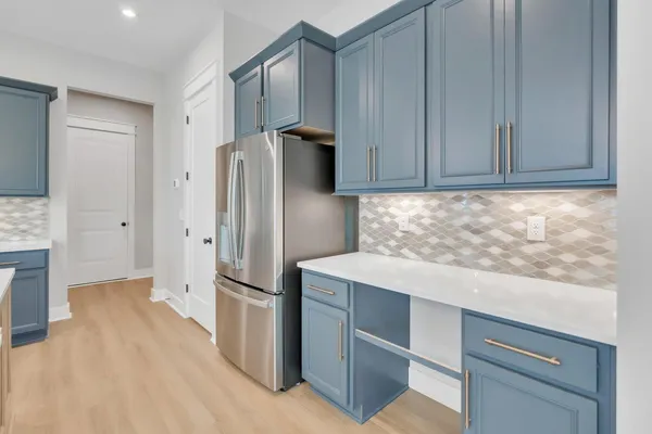a kitchen with a refrigerator and cabinets