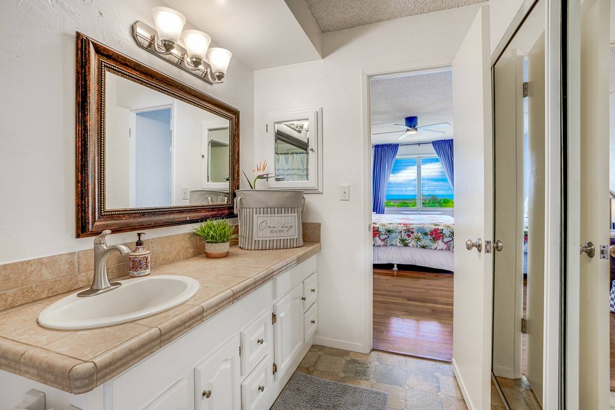 1763 Pe'e Road, Unit 204 Koloa, HI 96756 - Photo 8 of 29 a en suite bathroom with a sink double vanity and a mirror