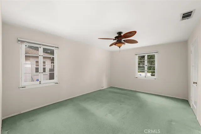 a view of room with a ceiling fan and window