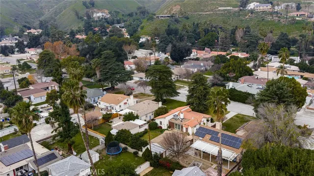 an aerial view of multiple houses with yard