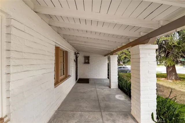 a kitchen with stainless steel appliances granite countertop a sink a stove a microwave cabinets and wooden floor