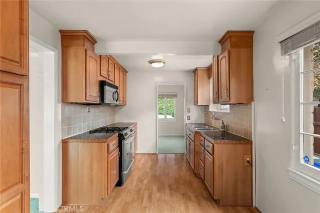an empty room with windows and fireplace
