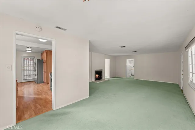 a view of an empty room and fire place