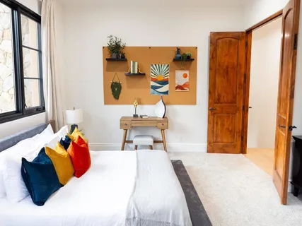 a bedroom with a bed and a window