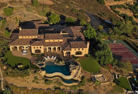 an aerial view of a house with garden space and sitting area