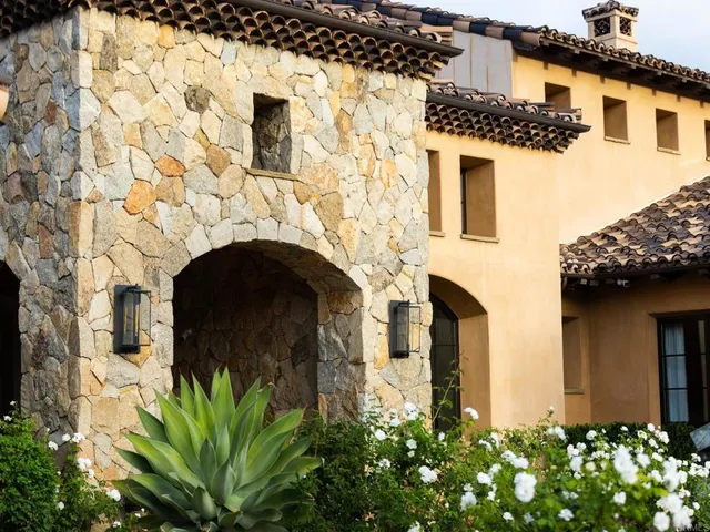 a front view of a house with plants