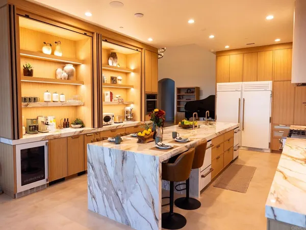 a kitchen with stainless steel appliances granite countertop a sink and a refrigerator