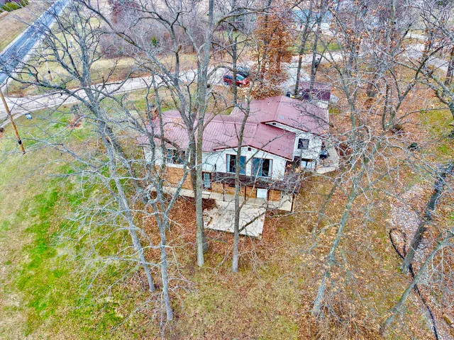 a view of house with yard and sitting area