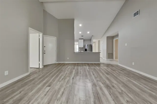 a view of a room with wooden floor and a window