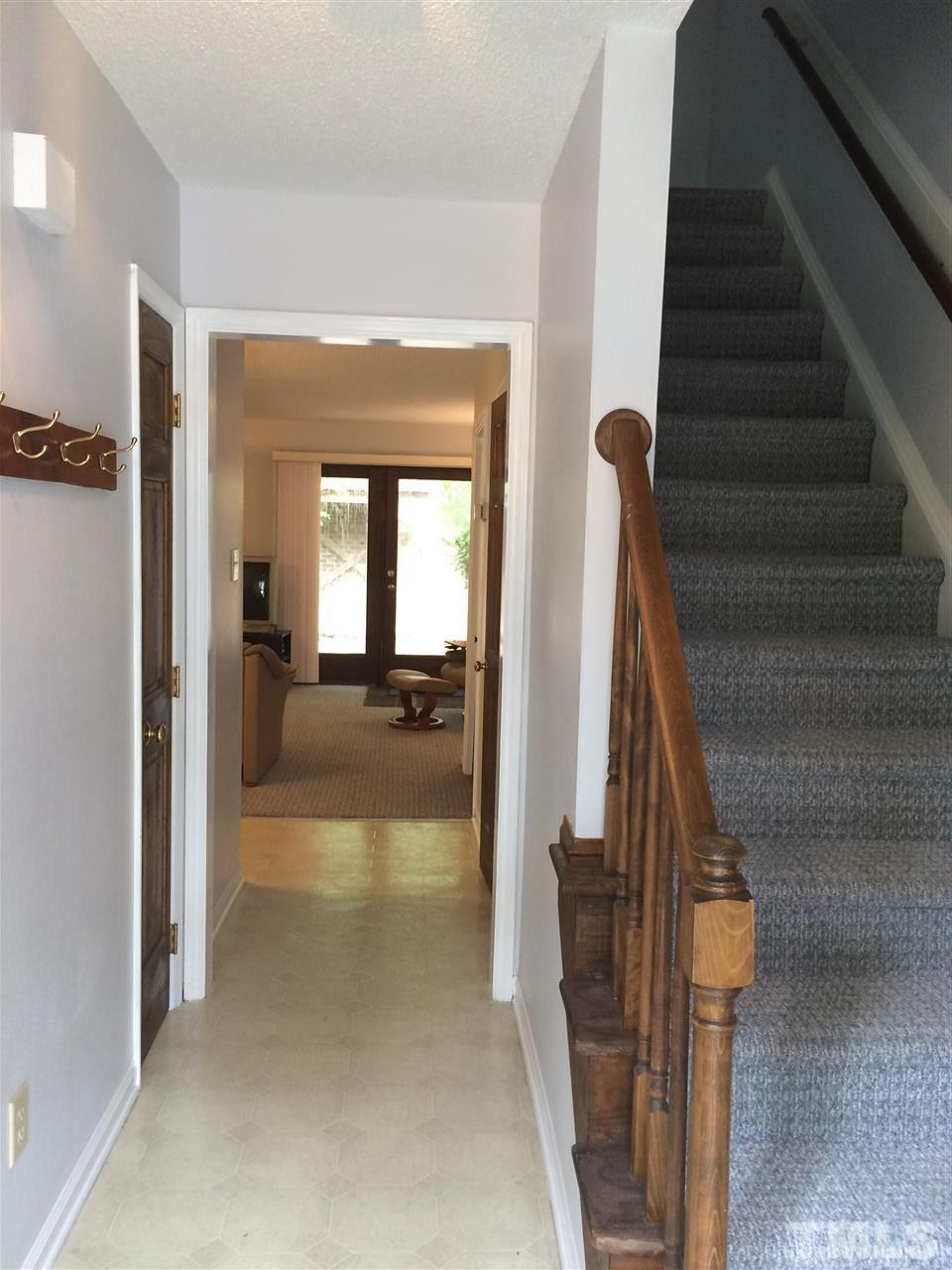 1412 Kent Road Raleigh, NC 27606 - Photo 3 of 18 a view of a hallway with wooden floor and staircase