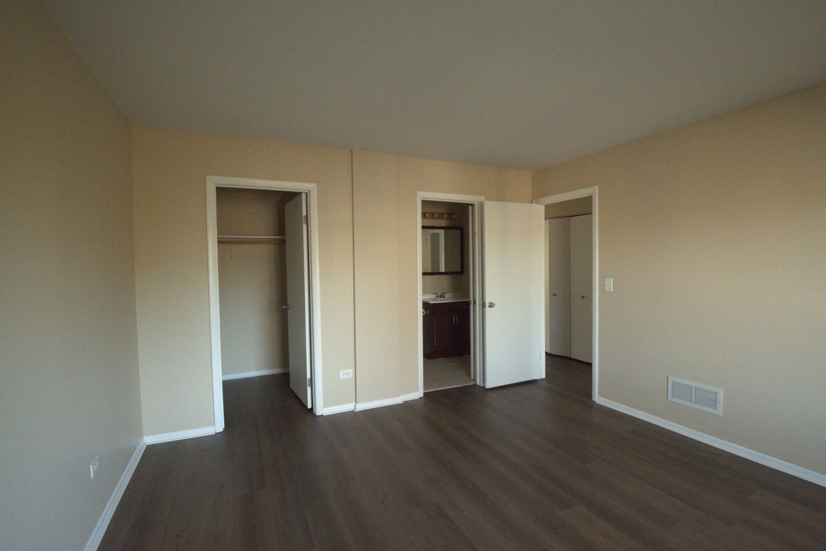 1045 Spring Mill Drive Hoffman Estates, IL 60169 - Photo 7 of 14 a view of an empty room with wooden floor and closet