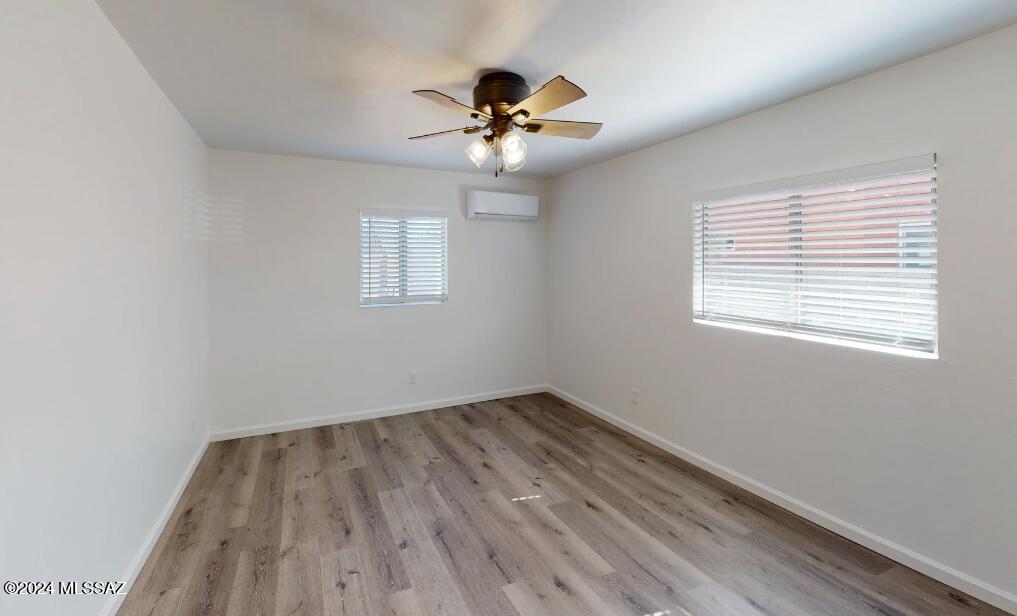 2118 North Rita Avenue Tucson, AZ 85716 - Photo 9 of 17 wooden floor in an empty room with a window