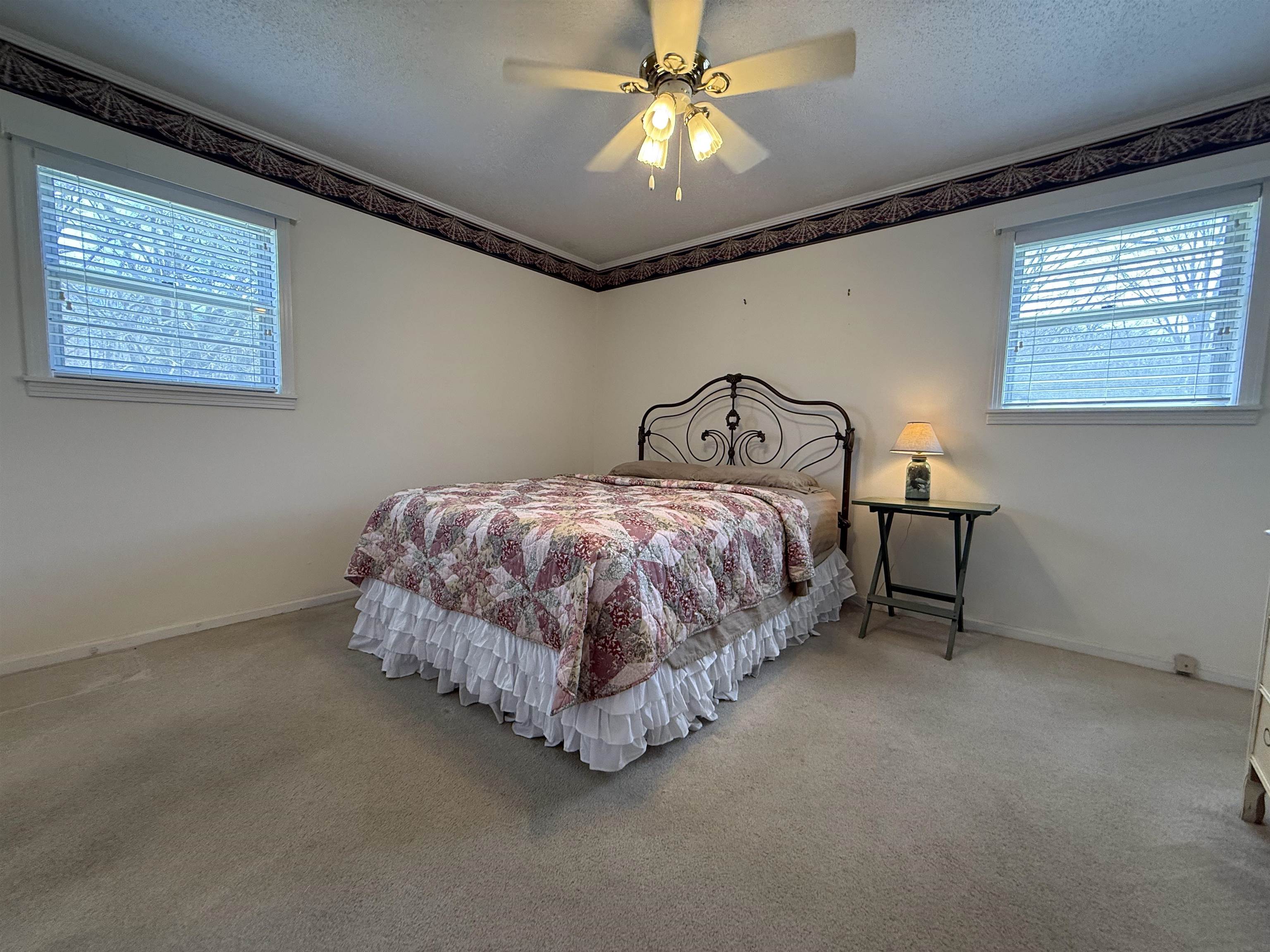 115 Robertson Drive Somerville, TN 38068 - Photo 12 of 19 a bedroom with a bed and a chandelier